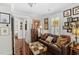Cozy living room with dark leather sofa and gallery wall featuring Gathering photos at 2010 W Dekle Ave, Tampa, FL 33606