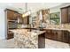 Modern kitchen with granite island and stainless steel appliances at 7110 N Taliaferro Ave, Tampa, FL 33604