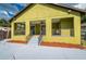Back exterior of the home showing a patio and steps at 7110 N Taliaferro Ave, Tampa, FL 33604