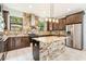 Modern kitchen with granite island and stainless steel appliances at 7110 N Taliaferro Ave, Tampa, FL 33604