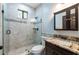 Bathroom with granite vanity and tiled shower at 7110 N Taliaferro Ave, Tampa, FL 33604