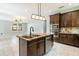 Modern kitchen with granite countertops, stainless steel appliances, and dark wood cabinets at 7110 N Taliaferro Ave, Tampa, FL 33604