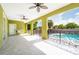 Covered patio with pool access and ceiling fans at 7110 N Taliaferro Ave, Tampa, FL 33604