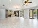 Open concept living room and kitchen with tile floors and multiple access points at 7110 N Taliaferro Ave, Tampa, FL 33604