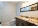 Bathroom with granite countertop vanity and glass shower at 7110 N Taliaferro Ave, Tampa, FL 33604
