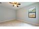 Bedroom with ceiling fan and large window at 7110 N Taliaferro Ave, Tampa, FL 33604