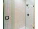 Modern shower with glass enclosure and marble tile at 7110 N Taliaferro Ave, Tampa, FL 33604