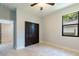 Bedroom with double door closet and tile floors at 7110 N Taliaferro Ave, Tampa, FL 33604