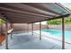 Covered patio area next to the refreshing swimming pool at 7110 N Taliaferro Ave, Tampa, FL 33604