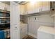 Convenient laundry room with washer, dryer, and overhead shelving at 717 N Himes Ave, Tampa, FL 33609