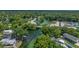 Aerial view of a community near a lush green river at 5369 Tuscawilla Dr, Weeki Wachee, FL 34607