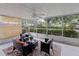 Relaxing screened porch with wicker furniture and view of water at 5369 Tuscawilla Dr, Weeki Wachee, FL 34607