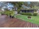 Large backyard with a deck, firepit and screened porch at 5369 Tuscawilla Dr, Weeki Wachee, FL 34607