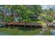 Charming home with a dock, lush landscaping, and private backyard at 5369 Tuscawilla Dr, Weeki Wachee, FL 34607