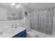 Updated bathroom with white subway tile, blue vanity, and a shower/tub combo at 5369 Tuscawilla Dr, Weeki Wachee, FL 34607