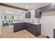 Modern kitchen with dark cabinetry, quartz countertops, and an island at 5369 Tuscawilla Dr, Weeki Wachee, FL 34607
