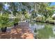 Wooden dock extending over calm canal waters at 5369 Tuscawilla Dr, Weeki Wachee, FL 34607