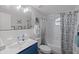 Updated bathroom with white subway tile, blue vanity, and a shower/tub combo at 5369 Tuscawilla Dr, Weeki Wachee, FL 34607