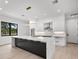 Modern kitchen with large island and white cabinets at 5341 Lake Pearl Ct, Tampa, FL 33625