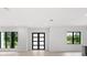 Modern entryway with glass and black door and hardwood floors at 5341 Lake Pearl Ct, Tampa, FL 33625
