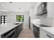Modern kitchen with white cabinets, geometric backsplash and stainless steel appliances at 5341 Lake Pearl Ct, Tampa, FL 33625