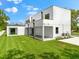 Contemporary home with backyard, covered patio, and lush lawn at 5341 Lake Pearl Ct, Tampa, FL 33625