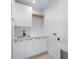 Bright laundry room featuring white cabinetry and quartz countertops at 5341 Lake Pearl Ct, Tampa, FL 33625