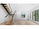 Modern floating staircase with glass railings and wooden steps at 5341 Lake Pearl Ct, Tampa, FL 33625
