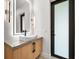 Bright bathroom with a modern floating sink and frosted glass door at 5341 Lake Pearl Ct, Tampa, FL 33625