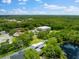 Aerial view of property near a lake with surrounding vegetation at 5341 Lake Pearl Ct, Tampa, FL 33625