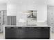 Modern kitchen with white cabinets, marble countertops, and a statement light fixture at 5341 Lake Pearl Ct, Tampa, FL 33625