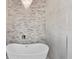 Relaxing bathroom with a freestanding tub and stone tile feature wall at 5341 Lake Pearl Ct, Tampa, FL 33625
