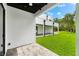 Covered back patio with tile flooring, ceiling fan, and view of backyard at 5341 Lake Pearl Ct, Tampa, FL 33625