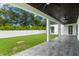 Modern covered patio with dark wood ceiling and tile flooring at 5341 Lake Pearl Ct, Tampa, FL 33625