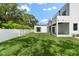 Spacious backyard with grassy lawn and white vinyl fence at 5341 Lake Pearl Ct, Tampa, FL 33625