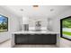 Modern kitchen with large island, stainless steel appliances, and backyard access at 5341 Lake Pearl Ct, Tampa, FL 33625