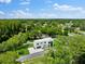 Aerial view of modern home with large backyard and neighborhood in background at 5341 Lake Pearl Ct, Tampa, FL 33625