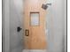 Walk-in shower with modern gray tile and wood-look accent wall at 5341 Lake Pearl Ct, Tampa, FL 33625