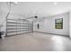 Spacious garage with epoxy flooring and overhead storage at 5341 Lake Pearl Ct, Tampa, FL 33625