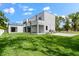 Modern home with expansive lawn, large patio, and a rooftop deck at 5341 Lake Pearl Ct, Tampa, FL 33625