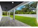 Covered patio with dark ceiling, tile floor, and ceiling fans at 5341 Lake Pearl Ct, Tampa, FL 33625
