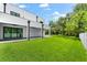 Expansive backyard with grassy lawn and a white fence at 5341 Lake Pearl Ct, Tampa, FL 33625