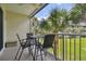 Private balcony with table and chairs, overlooking a grassy area at 424 Bahia Beach Blvd, Ruskin, FL 33570