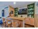 Tropical-themed bar with seating and shelving in a basement rec room at 424 Bahia Beach Blvd, Ruskin, FL 33570