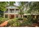 Two-story brick home with a wrap-around porch and mature landscaping at 2271 Keystone Rd, Tarpon Springs, FL 34688
