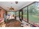 Screened porch with brick flooring and backyard view at 2271 Keystone Rd, Tarpon Springs, FL 34688
