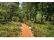 Brick pathway meandering through a garden at 2271 Keystone Rd, Tarpon Springs, FL 34688