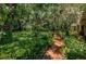 Brick pathway beside lush greenery near the house at 2271 Keystone Rd, Tarpon Springs, FL 34688