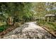 Driveway with landscaping and a brick-paved path at 2271 Keystone Rd, Tarpon Springs, FL 34688