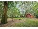 Red barn in a wooded backyard setting at 2271 Keystone Rd, Tarpon Springs, FL 34688